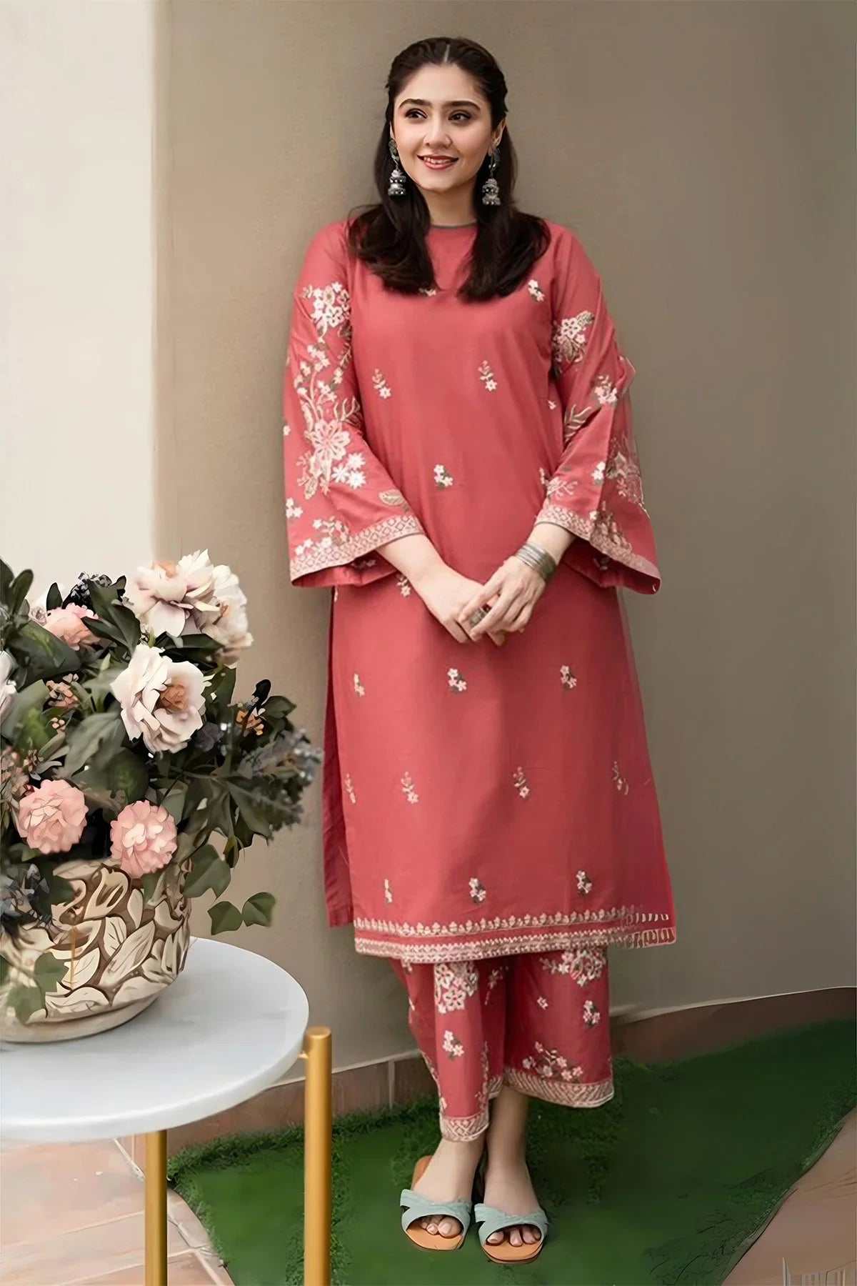 Woman wearing pink READY TO WEAR lawn embroidered shirt and matching trousers with floral details